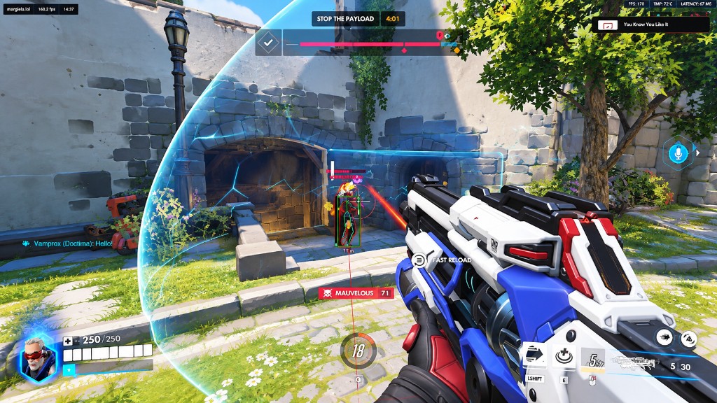 Soldier: 76 firing through a barrier with a boxed enemy and an aim line on target.